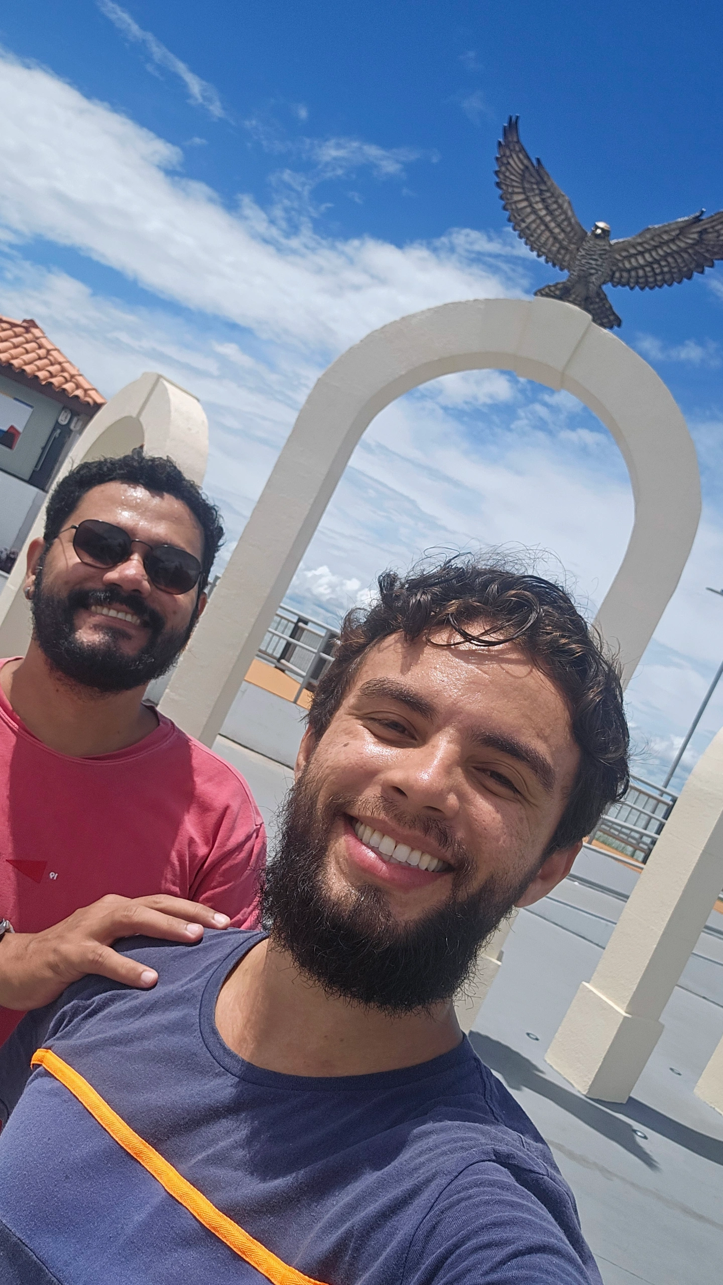 Venilson e Walterly sorrindo em selfie com mar ao fundo